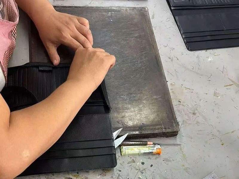 Quelles inspections de qualité Godere effectue-t-il avant l'expédition du portefeuille ?